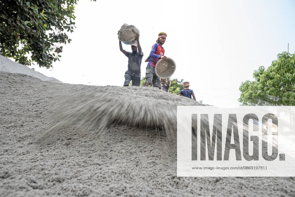 Migrant Workers Unload Sand Workers unload sand at a riverside site in Gabtoli, Dhaka, Bangladesh, on October 11, 2026. Many have left rural communities in search of employment in the capital, where daily labor provides a source of income but often involves strenuous work and limited financial security. Dhaka Bangladesh