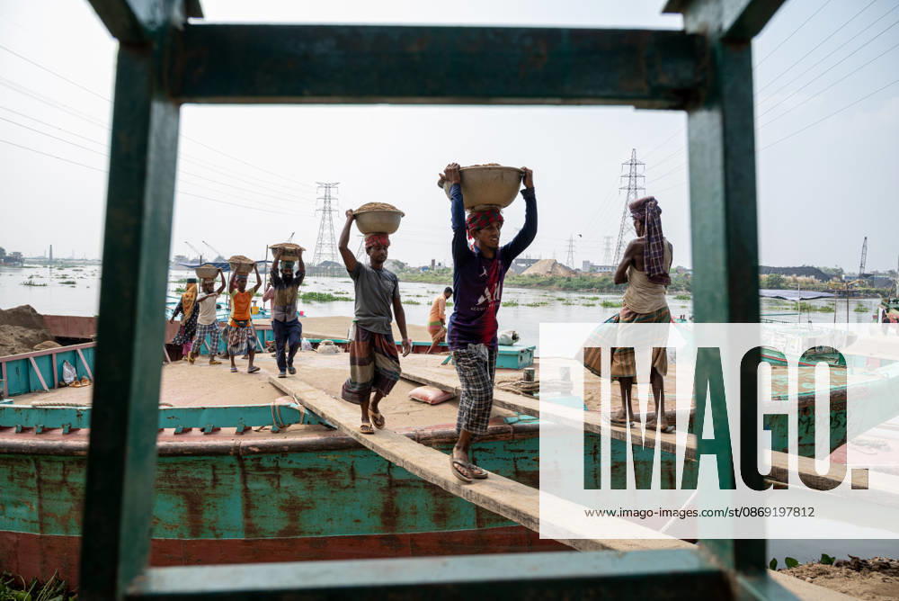 Migrant Workers Unload Sand Workers unload sand at a riverside site in Gabtoli, Dhaka, Bangladesh, on October 11, 2026. Many have left rural communities in search of employment in the capital, where daily labor provides a source of income but often involves strenuous work and limited financial security. Dhaka Bangladesh