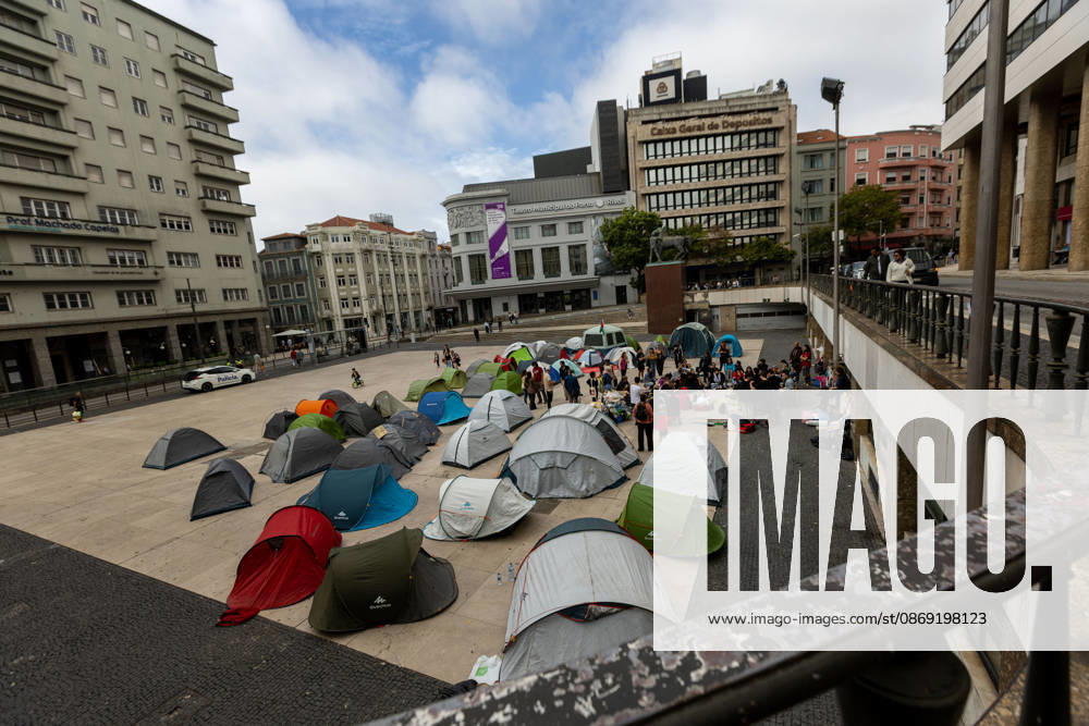 Participants have a public assembly beside a temporary encampment in Praca D. Joao I during an overnight occupation organized by the Nao Da Mais Para Viver Assim? movement following demonstrations against the housing crisis and rising living costs. Porto Portugal - ZUMAs197 20261011_aaa_s197_045