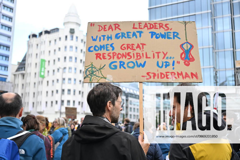 Tens of thousands march in Brussels demanding stronger climate action BRUSSELS, BELGIUM - OCTOBER 11: Demonstrators hold climate-themed placards as tens of thousands of people march through Brussels calling for stronger action against climate change and reduced dependence on fossil fuels, on October 11, 2026 in Brussels, Belgium. The protest was organized by the Belgian Climate Coalition, which brings together around 100 civil society organizations. Participants marched along major roads toward Schuman Square, home to several European Union institutions, while protesting the government s climate policies. Dursun Aydemir Anadolu Brussels Belgium. Editorial use only. Please get in touch for any other usage.