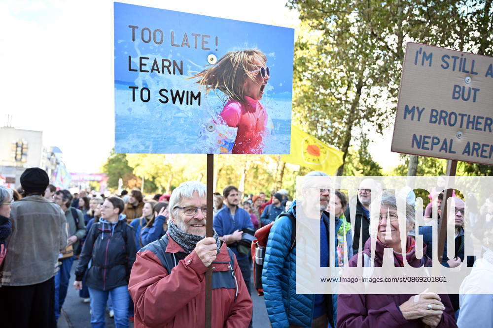 Tens of thousands march in Brussels demanding stronger climate action BRUSSELS, BELGIUM - OCTOBER 11: Demonstrators hold climate-themed placards as tens of thousands of people march through Brussels calling for stronger action against climate change and reduced dependence on fossil fuels, on October 11, 2026 in Brussels, Belgium. The protest was organized by the Belgian Climate Coalition, which brings together around 100 civil society organizations. Participants marched along major roads toward Schuman Square, home to several European Union institutions, while protesting the government s climate policies. Dursun Aydemir Anadolu Brussels Belgium. Editorial use only. Please get in touch for any other usage.