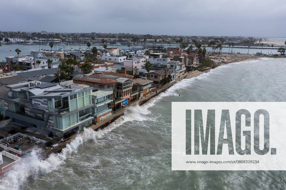 The Long Beach Peninsula is facing severe, structural devastation as Tropical Storm Rachel batters the Southern California coast. Driven by a developing El Nino pattern, this is the fourth major storm system to slam the shoreline in six weeks. Waves and unusually high tides have shattered a 30-foot section of the protective wooden bulkhead, completely shredding the historic boardwalk and allowing seawater to surge directly onto interior streets. Flooding has swamped coastal neighborhoods, forcing mandatory evacuations along oceanfront blocks like Seaside Walk. Emergency crews are working to stack thousands of sandbags and reinforce coastal defenses, but city inspectors have already been forced - ZUMAr19_ 20261011_new_r19_124