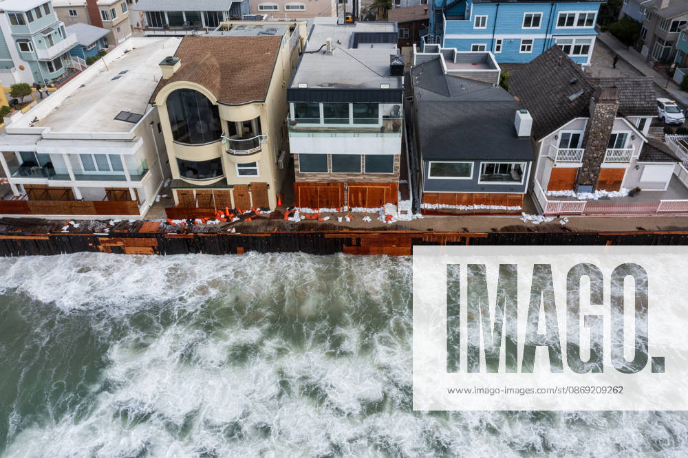 The Long Beach Peninsula is facing severe, structural devastation as Tropical Storm Rachel batters the Southern California coast. Driven by a developing El Nino pattern, this is the fourth major storm system to slam the shoreline in six weeks. Waves and unusually high tides have shattered a 30-foot section of the protective wooden bulkhead, completely shredding the historic boardwalk and allowing seawater to surge directly onto interior streets. Flooding has swamped coastal neighborhoods, forcing mandatory evacuations along oceanfront blocks like Seaside Walk. Emergency crews are working to stack thousands of sandbags and reinforce coastal defenses, but city inspectors have already been forced - ZUMAr19_ 20261011_new_r19_122