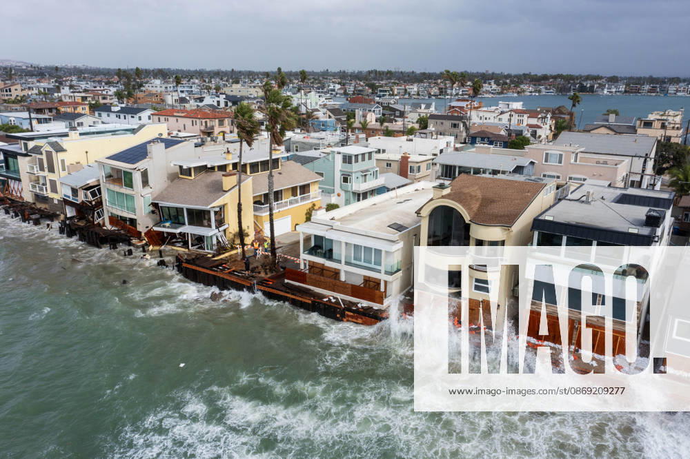The Long Beach Peninsula is facing severe, structural devastation as Tropical Storm Rachel batters the Southern California coast. Driven by a developing El Nino pattern, this is the fourth major storm system to slam the shoreline in six weeks. Waves and unusually high tides have shattered a 30-foot section of the protective wooden bulkhead, completely shredding the historic boardwalk and allowing seawater to surge directly onto interior streets. Flooding has swamped coastal neighborhoods, forcing mandatory evacuations along oceanfront blocks like Seaside Walk. Emergency crews are working to stack thousands of sandbags and reinforce coastal defenses, but city inspectors have already been forced - ZUMAr19_ 20261011_new_r19_126