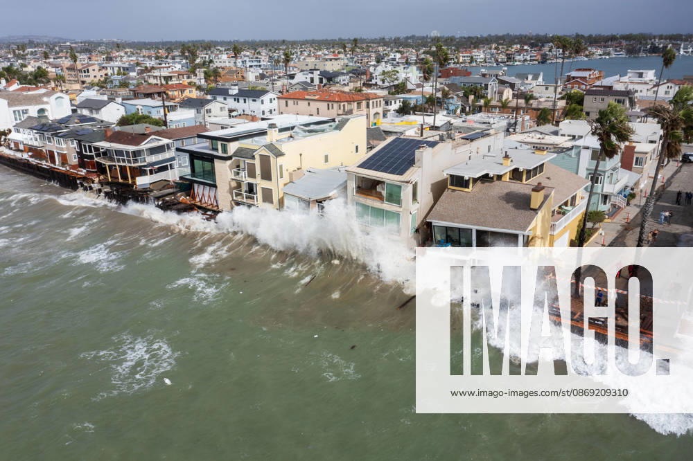 The Long Beach Peninsula is facing severe, structural devastation as Tropical Storm Rachel batters the Southern California coast. Driven by a developing El Nino pattern, this is the fourth major storm system to slam the shoreline in six weeks. Waves and unusually high tides have shattered a 30-foot section of the protective wooden bulkhead, completely shredding the historic boardwalk and allowing seawater to surge directly onto interior streets. Flooding has swamped coastal neighborhoods, forcing mandatory evacuations along oceanfront blocks like Seaside Walk. Emergency crews are working to stack thousands of sandbags and reinforce coastal defenses, but city inspectors have already been forced - ZUMAr19_ 20261011_new_r19_132