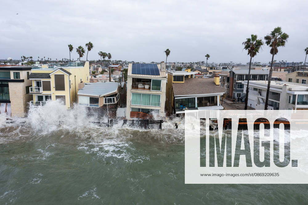 The Long Beach Peninsula is facing severe, structural devastation as Tropical Storm Rachel batters the Southern California coast. Driven by a developing El Nino pattern, this is the fourth major storm system to slam the shoreline in six weeks. Waves and unusually high tides have shattered a 30-foot section of the protective wooden bulkhead, completely shredding the historic boardwalk and allowing seawater to surge directly onto interior streets. Flooding has swamped coastal neighborhoods, forcing mandatory evacuations along oceanfront blocks like Seaside Walk. Emergency crews are working to stack thousands of sandbags and reinforce coastal defenses, but city inspectors have already been forced - ZUMAr19_ 20261011_new_r19_140