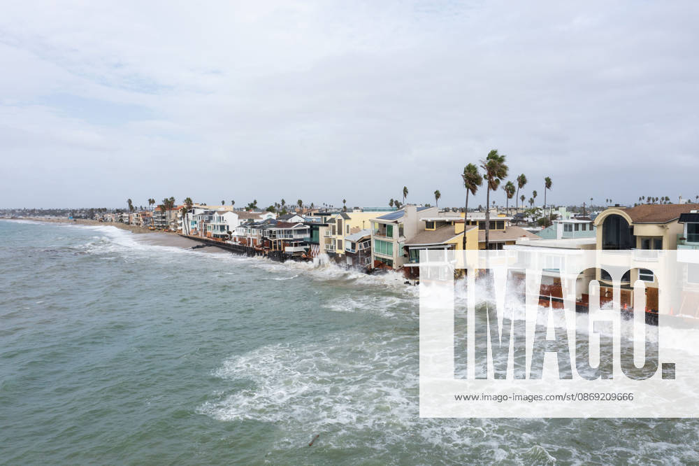 The Long Beach Peninsula is facing severe, structural devastation as Tropical Storm Rachel batters the Southern California coast. Driven by a developing El Nino pattern, this is the fourth major storm system to slam the shoreline in six weeks. Waves and unusually high tides have shattered a 30-foot section of the protective wooden bulkhead, completely shredding the historic boardwalk and allowing seawater to surge directly onto interior streets. Flooding has swamped coastal neighborhoods, forcing mandatory evacuations along oceanfront blocks like Seaside Walk. Emergency crews are working to stack thousands of sandbags and reinforce coastal defenses, but city inspectors have already been forced - ZUMAr19_ 20261011_new_r19_141