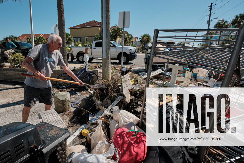 Pensacola Beach, Florida, U.S: October 11, 2026 Pensacola Beach, Florida USA: A resident of a storm damaged apartment complex unloads his shovel on a pile of trash while cleaning out his apartment after the arrival of Hurricane Isaias. Pensacola Beach U.S - ZUMAa14_ 20261011_zaf_a14_004