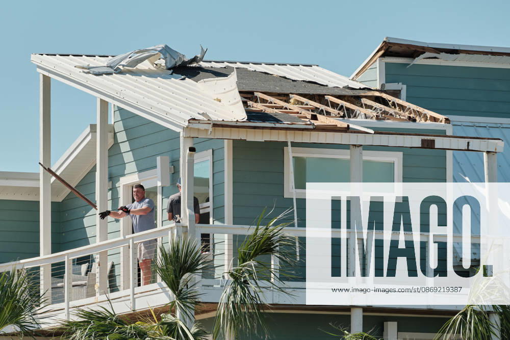 Pensacola Beach, Florida, U.S: October 11, 2026 Pensacola Beach, Florida USA: People throw out debris from the top of a storm damaged house after the arrival of Hurricane Isaias. Pensacola Beach U.S - ZUMAa14_ 20261011_zaf_a14_006