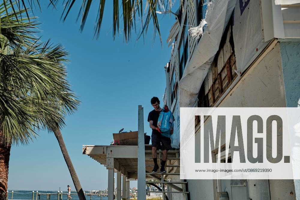 Pensacola Beach, Florida, U.S: October 11, 2026 Pensacola Beach, Florida USA: Alex Dean carries belonging out of his storm damaged apartment complex after the arrival of Hurricane Isaias. Pensacola Beach U.S - ZUMAa14_ 20261011_zaf_a14_007