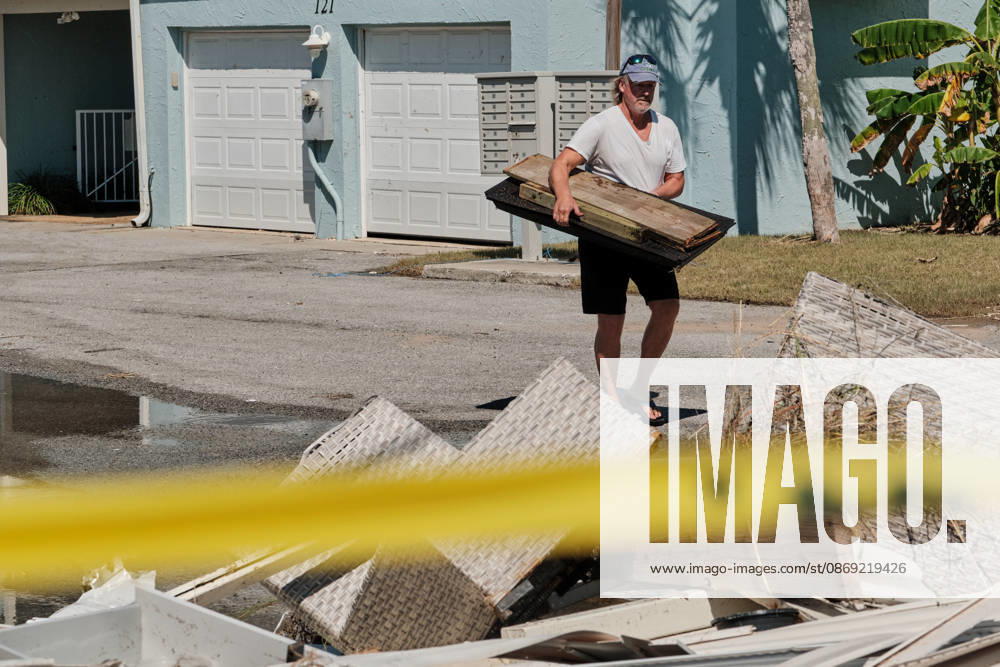 Pensacola Beach, Florida, U.S: October 11, 2026 Pensacola Beach, Florida USA: A resident of a storm damaged apartment complex unloads his shovel on a pile of trash while cleaning out his apartment after the arrival of Hurricane Isaias. Pensacola Beach U.S - ZUMAa14_ 20261011_zaf_a14_015