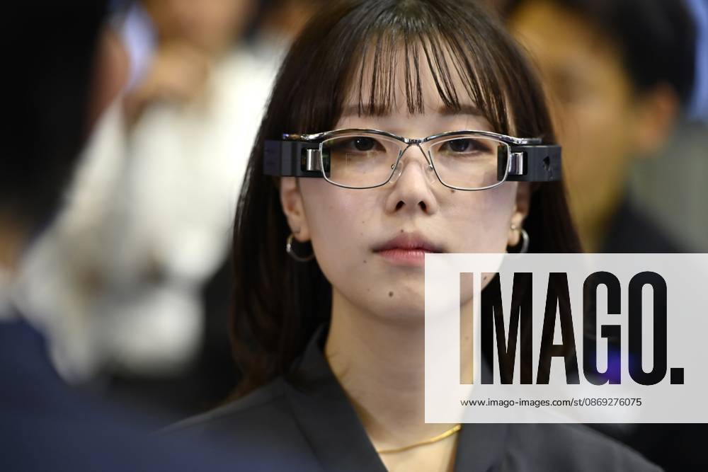 Japan showcases emerging technologies at CEATEC 2026 CHIBA, JAPAN - OCTOBER 13: A visitor tries on a prototype of smart glasses featuring Meta-Optic Mirror technology developed by Japanese electronics company TDK during CEATEC 2026 at Makuhari Messe in Chiba, Japan, October 13, 2026. The prototype uses an ultra-thin optical mirror to direct projected images onto the retina, with TDK aiming to develop more compact and conventional-looking smart glasses. David Mareuil Anadolu Chiba Japan. Editorial use only. Please get in touch for any other usage.