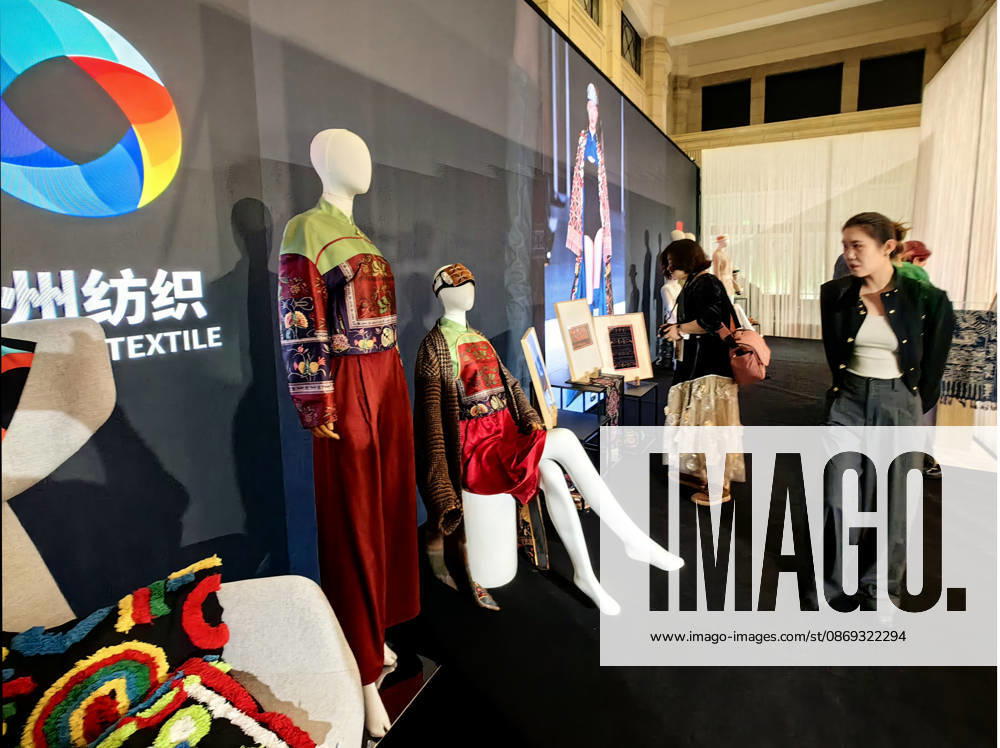 Models present designs featuring traditional intangible cultural heritage elements during the Shanghai Fashion Week LIVING HERITAGE event on October 13, 2026 in Shanghai, China. The season highlights contemporary adaptations of traditional crafts including Miao embroidery and wax printing from Guizhou Province.