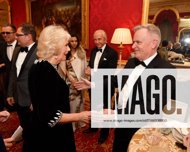 . 21 11 2018. London, United Kingdom. The Duchess of Cornwall is greeted by Lord Jeffrey Archer at a Julien MacDonald fashion show and reception at Lancaster House in London in aid of the National Osteoporosis Society charity xi-Imagesx IIM-18903-0009