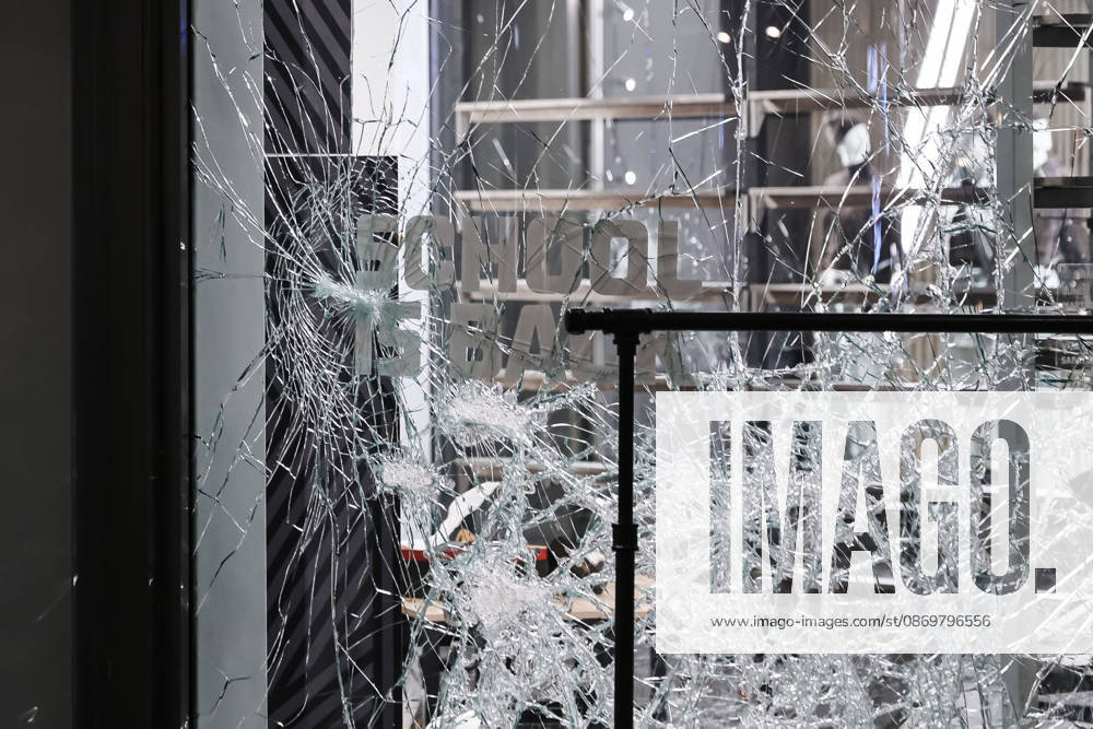 IPA89830535 - Milan: Damage caused by clashes between protesters and police during the Italia in Piazza demonstration against the high cost of living in the city center. Pictured: Damage to the Foot Locker store on Corso Vittorio Emanuele II