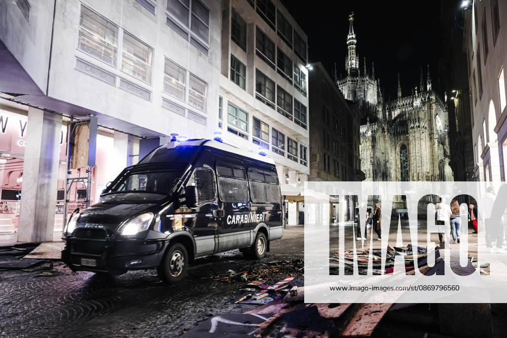 IPA89830419 - Milan: Damage caused by clashes between protesters and police during the Italia in Piazza demonstration against the high cost of living in the city center. Pictured: Police and Carabinieri on Corso Vittorio Emanuele II