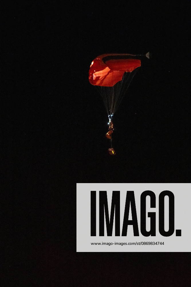 A person parachutes near the Wainwright Health Centre as injured military members are treated after a fire at CFB Wainwright, outside of Wainwright, Alta., on Saturday, Oct. 17, 2026. Wainwright Canada - ZUMAc35_ 20261017_zaf_c35_157