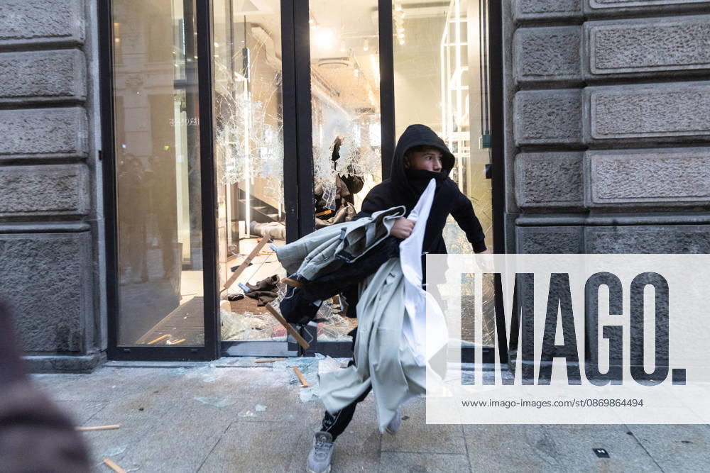 IPA89867498 - Milan, October 18, 2026: More Clashes and Looting in Downtown Milan the Day After the Protest; Rioters Storm a Brand-Name Store, Emerging with Stolen Goods and Clothing