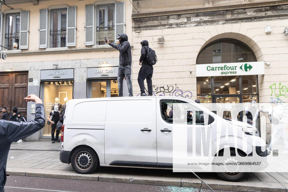 IPA89867709 - Milan, October 18, 2026: More Clashes and Looting in Downtown Milan the Day After the Protest; Pictured: Via Torino Rioters Storm the Carrefour