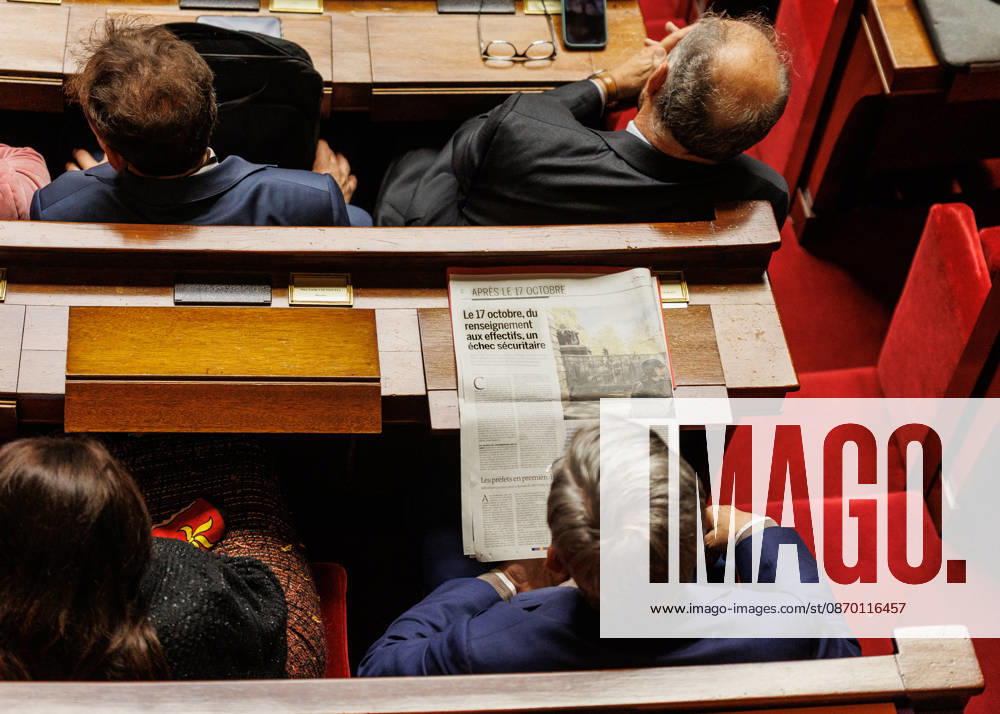 A member of parliament in the national assembly is looking at the newspaper Le Monde during the session. - ZUMAs287 20261020_zip_s287_030