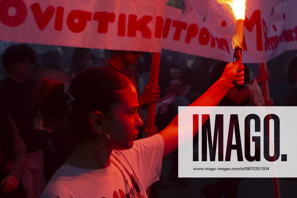 Athens Greece Living Costs Protest A protester holds a flare beside banners during a rally in Athens, Greece on October 21, 2026. Students and other demonstrators marched through central Athens to protest rising living costs and economic pressures. Organizers say the concerns raised by participants echo grievances voiced during recent demonstrations in France. Athens Attica Greece