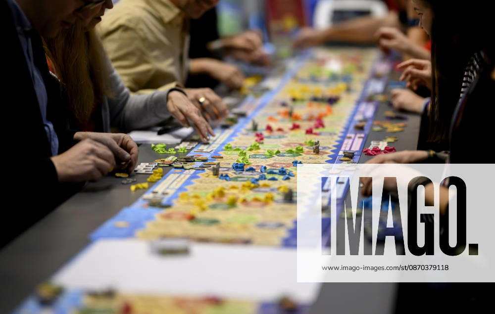 Besucher und Besucherinnen Spielen die Siedler von Catan (Kosmos) an einem langen Tisch, Spieltisch, am 22.10.2026 Messe SPIEL Essen vom 22.10 - 25.10.2026 in E s s e n Deutschland. Grugahalle
