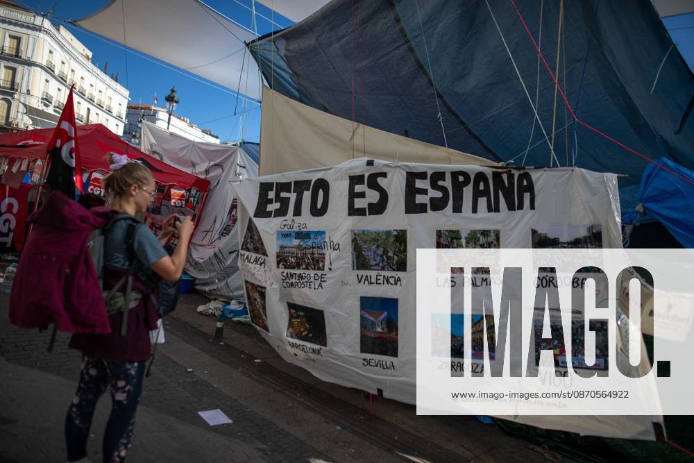 A banner featuring photographs and the phrase This is Spain can be seen at Puerta del Sol..Tents remain set up by housing rights activists, who organized the occupation of the square in response to the eviction of Maricarmen a woman in her eighties from her home, carried out by a real estate investment fund. Madrid Spain - ZUMAs197 20261023_aaa_s197_153