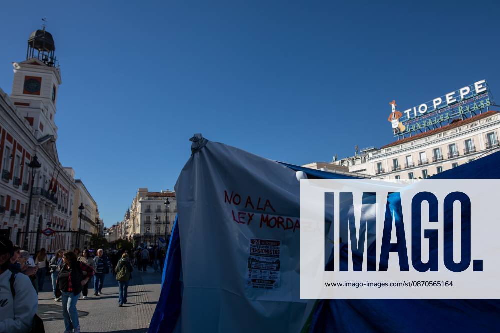 A banner with the phrase No to the gag law (Ley Mordaza) can be seen at Puerta del Sol..Tents remain set up by housing rights activists, who organized the occupation of the square in response to the eviction of Maricarmenâ€a woman in her eightiesâ€from her home, carried out by a real estate investment fund. Madrid Spain - ZUMAs197 20261023_aaa_s197_151