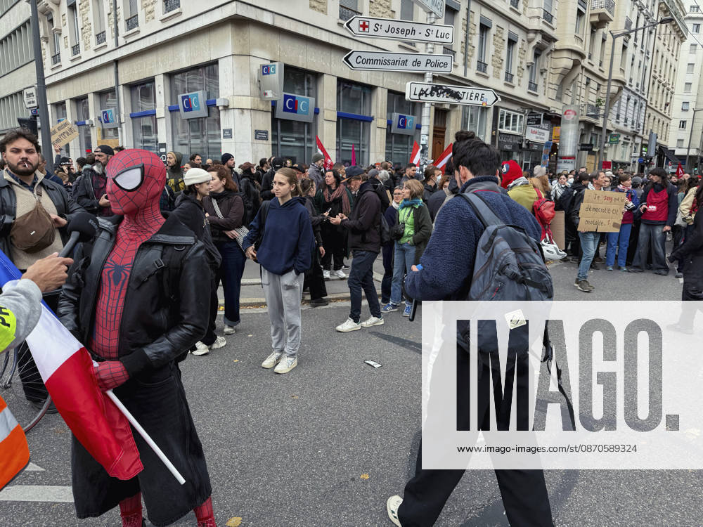 Lyon France Anti-Government Protest A demonstrator wearing a Spider-Man mask holds a French flag as protesters gather on a street in Lyon, France, on October 24, 2026. The demonstration took place amid renewed protests over living costs, wages and public services, while authorities restricted gatherings in parts of central Lyon following unrest during demonstrations the previous weekend. Lyon Rhone Alpes France