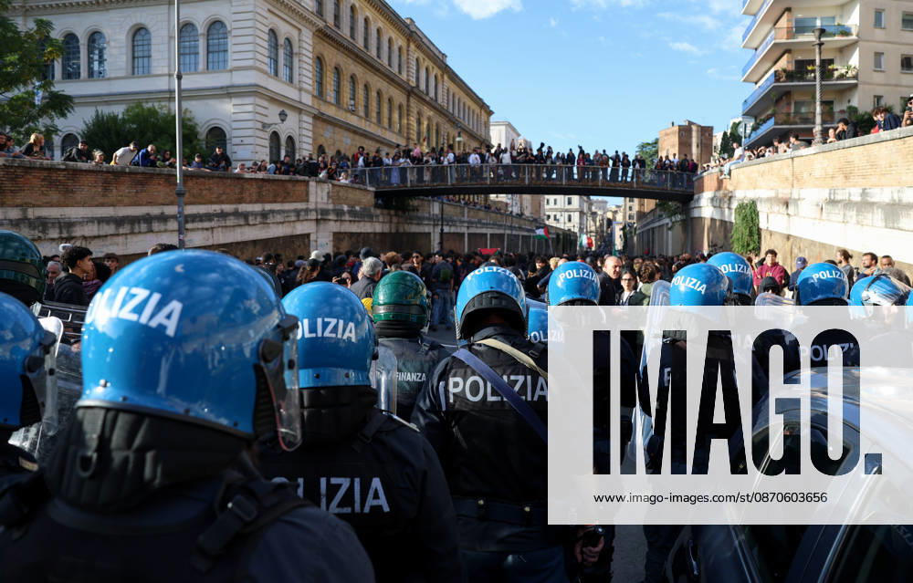 (261024) -- ROME, Oct. 24, 2026 -- Police block the demonstrators from marching towards the Colosseum during an anti-war march in Rome, Italy, Oct. 24, 2026. Protests over rising living costs, military expansion and increased arms spending swept across several Italian cities on Saturday, with clashes between demonstrators and police reported in multiple locations. In Rome, demonstrators set off from Piazza della Repubblica, according to the ANSA news agency. Clashes erupted between protesters and police in the city center later in the evening, prompting police to use water cannons and tear gas in an attempt to disperse the crowds. ) ITALY-ROME-PROTESTS WangxKaiyan