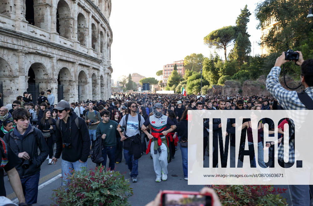 (261024) -- ROME, Oct. 24, 2026 -- Demonstrators march past the Colosseum during an anti-war march in Rome, Italy, Oct. 24, 2026. Protests over rising living costs, military expansion and increased arms spending swept across several Italian cities on Saturday, with clashes between demonstrators and police reported in multiple locations. In Rome, demonstrators set off from Piazza della Repubblica, according to the ANSA news agency. Clashes erupted between protesters and police in the city center later in the evening, prompting police to use water cannons and tear gas in an attempt to disperse the crowds. ) ITALY-ROME-PROTESTS WangxKaiyan