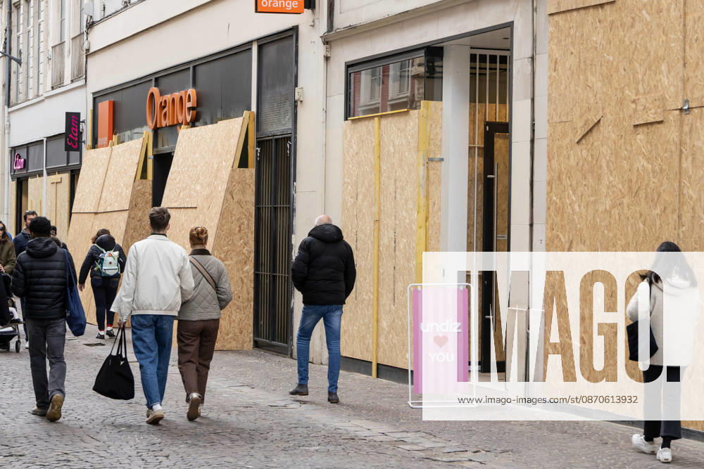 (261024) -- LILLE, Oct. 24, 2026 -- People walk past boarded-up shops in Lille, France, Oct. 24, 2026. Around 410,000 people took part in a new round of protests across France on Saturday, French news channel BFM TV reported, citing the Interior Ministry. (Photo by Xinhua) FRANCE-LILLE-PROTEST SebastienxCourdji