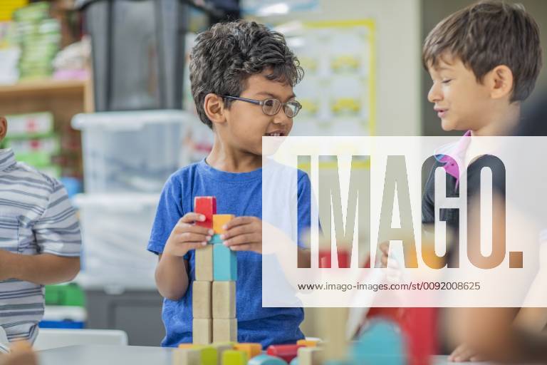 Boys talking and playing with building blocks in kindergarten model released Symbolfoto property released ZEF15436