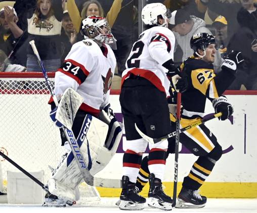 Pittsburgh Penguins right wing Rickard Rakell (67) skates pass Ottawa Senators goaltender Dylan Ferguson (34) as he celebrates his third period goal at PPG Paints Arena in Pittsburgh on Monday, March 20, 2023. PIT2023032016 ARCHIExCARPENTER