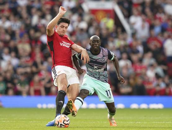 Manchester, England, 7th October 2023. Harry Maguire of Manchester United, ManU tackles Yoane Wissa of Brentford during the Premier League match at Old Trafford, Manchester. Picture credit should read: Andrew Yates Sportimage EDITORIAL USE ONLY. No use with unauthorised audio, video, data, fixture lists, club league logos or live services. Online in-match use limited to 120 images, no video emulation. No use in betting, games or single club league player publications. SPI-2635-0029