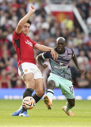 Manchester, England, 7th October 2023. Harry Maguire of Manchester United, ManU tackles Yoane Wissa of Brentford during the Premier League match at Old Trafford, Manchester. Picture credit should read: Andrew Yates Sportimage EDITORIAL USE ONLY. No use with unauthorised audio, video, data, fixture lists, club league logos or live services. Online in-match use limited to 120 images, no video emulation. No use in betting, games or single club league player publications. SPI-2635-0030