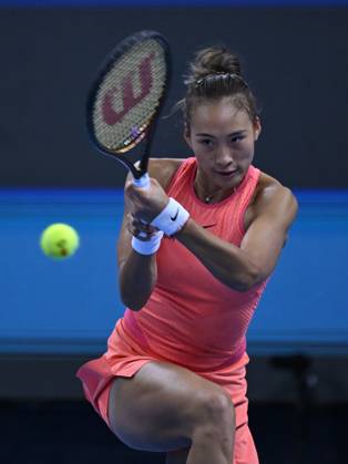 (241003) -- BEIJING, Oct. 3, 2024 -- Zheng Qinwen hits a return during the women s singles round of 16 match between Amanda Anisimova of the United States and Zheng Qinwen of China at the 2024 China Open tennis tournament in Beijing, China, Oct. 2, 2024. ) (SP)CHINA-BEIJING-TENNIS-CHINA OPEN-WOMEN S SINGLES(CN) ZhangxLong