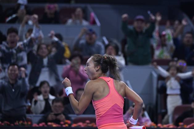 (241005) -- BEIJING, Oct. 5, 2024 -- Zheng Qinwen celebrates victory after the women s singles quarterfinal match between Zheng Qinwen of China and Mirra Andreeva of Russia at the 2024 China Open tennis tournament in Beijing, China, Oct. 4, 2024. ) XINHUA PHOTOS OF THE DAY ZhangxLong