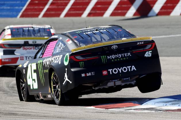CHARLOTTE, NC - OCTOBER 12: Tyler Reddick ( 45 23XI Racing Monster Energy Toyota) drives over the rumble strips in turn 16 during qualifying for the NASCAR, Motorsport, USA Cup Series Bank of America ROVAL 400 on October 12, 2024 at Charlotte Motor Speedway in Charlotte, NC. (Photo by Jeff Robinson Icon Sportswire) AUTO: OCT 12 NASCAR Cup Series Bank of America ROVAL 400 EDITORIAL USE ONLY Icon2410123108400