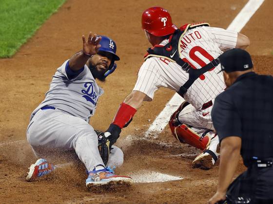 Los Angeles Dodgers Teoscar Hernandez (37) slides into home to score past the tag of Philadelphia Phillies catcher J.T. Realmuto (10) in the seventh inning during game two of the MLB, Baseball Herren, USA National League Division Series at Citizens Bank Park in Philadelphia on Monday, October 6, 2025. PHI20251006815 LAURENCExKESTERSON
