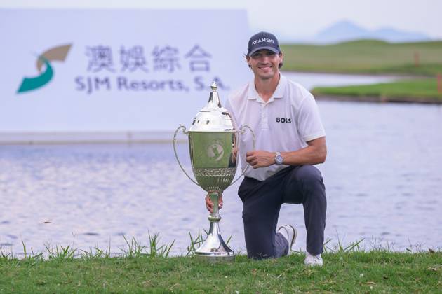 October 19, 2025, Macao, Macao Sar, China: Macau Open Golf , Final Round, Macau Golf and Country Club Coloane, Macao, China . Germanyâ€⠢s Dominic Foos Wins the Macau Open Golf after a tiebreaker with Taiwans Wang, Wei-hsuan. Foos holds the cup by the lake on the 18th fairway. Macao China - ZUMAr144 20251019_zap_r144_008 Copyright: xJaynexRussellx