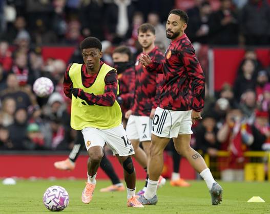 Manchester, England, 25th October 2025. Amad Diallo of Manchester United, ManU (l) and Matheus Cunha of Manchester United (r) warm up before the Manchester United vs Brighton and Hove Albion Premier League match at Old Trafford, Manchester. Picture credit should read: Andrew Yates Sportimage EDITORIAL USE ONLY. No use with unauthorised audio, video, data, fixture lists, club league logos or live services. Online in-match use limited to 120 images, no video emulation. No use in betting, games or single club league player publications. SPI_012_AY_Man_Utd_Brighton SPI-4237-0011