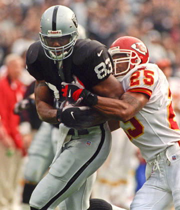 November 28, 1999 - Oakland, California, U.S - Oakland Raiders vs. Kansas City Chiefs at Oakland Alameda County Coliseum Sunday, November 29, 1999. Chiefs beat Raiders 37-34. Kansas City Chiefs defensive back Reggie Tonque (25) tackles Oakland Raiders tight end Rickey Dudley Copyright: xAlxGolubx