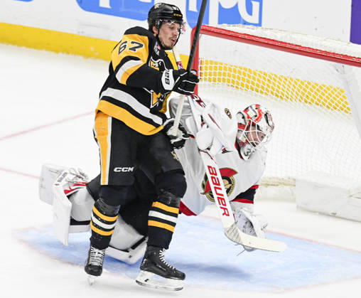 Pittsburgh Penguins right wing Rickard Rakell (67) receives a goalie Interference penalty as he collides with Ottawa Senators goaltender Linus Ullmark (35) during the first period at PPG Paints Arena in Pittsburgh on Monday, February 2, 2026. PIT2026020204 ARCHIExCARPENTER