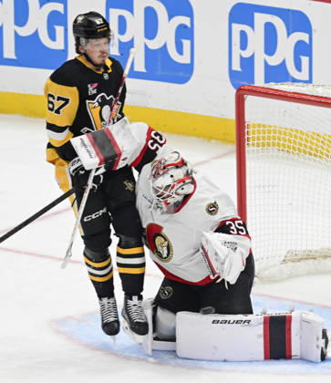 Pittsburgh Penguins right wing Rickard Rakell (67) receives a goalie Interference penalty as he collides with Ottawa Senators goaltender Linus Ullmark (35) during the first period at PPG Paints Arena in Pittsburgh on Monday, February 2, 2026. PIT2026020206 ARCHIExCARPENTER