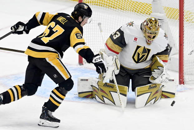 Pittsburgh Penguins right wing Rickard Rakell (67) chases the rebound off of Vegas Golden Knights goaltender Adin Hill (33) during the first period at PPG Paints Arena in Pittsburgh on Sunday, March 1, 2026. PIT2026030105 ARCHIExCARPENTER