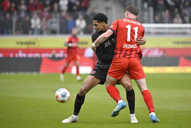 Zweikampf, Aktion Budu Zivzivadze Siwsiwadse 1. FC Heidenheim 1846 FCH (11) gegen Jarell Quansah Bayer 04 Leverkusen (04) 1. FC Heidenheim 1846 FCH vs Bayer 04 Leverkusen B04 21.03.2026 DFL REGULATIONS PROHIBIT ANY USE OF PHOTOGRAPHS AS IMAGE SEQUENCES AND OR QUASI-VIDEO 1. FC Heidenheim 1846 FCH vs Bayer 04 Leverkusen