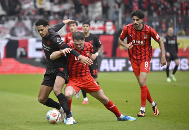 Zweikampf, Aktion Budu Zivzivadze Siwsiwadse 1. FC Heidenheim 1846 FCH (11) gegen Jarell Quansah Bayer 04 Leverkusen (04) Eren Dinkci 1. FC Heidenheim 1846 FCH (08) 1. FC Heidenheim 1846 FCH vs Bayer 04 Leverkusen B04 21.03.2026 DFL REGULATIONS PROHIBIT ANY USE OF PHOTOGRAPHS AS IMAGE SEQUENCES AND OR QUASI-VIDEO 1. FC Heidenheim 1846 FCH vs Bayer 04 Leverkusen