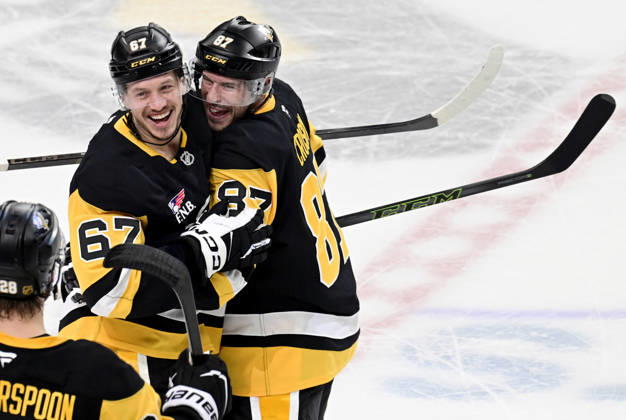 Pittsburgh Penguins right wing Rickard Rakell (67) celebrates his the overtime penalty shot goal with Pittsburgh Penguins center Sidney Crosby (87) following the Penguins 5-4 win against the Winnipeg Jets at PPG Paints Arena in Pittsburgh on Saturday, March 21, 2026. PIT2026032115 ARCHIExCARPENTER