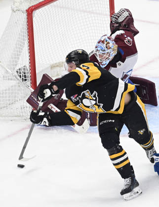 Pittsburgh Penguins right wing Rickard Rakell (67) attempts a backhanded shot on Colorado Avalanche goaltender Scott Wedgewood (41) during the second period at PPG Paints Arena in Pittsburgh on Tuesday, March 24, 2026. PIT2026032412 ARCHIExCARPENTER